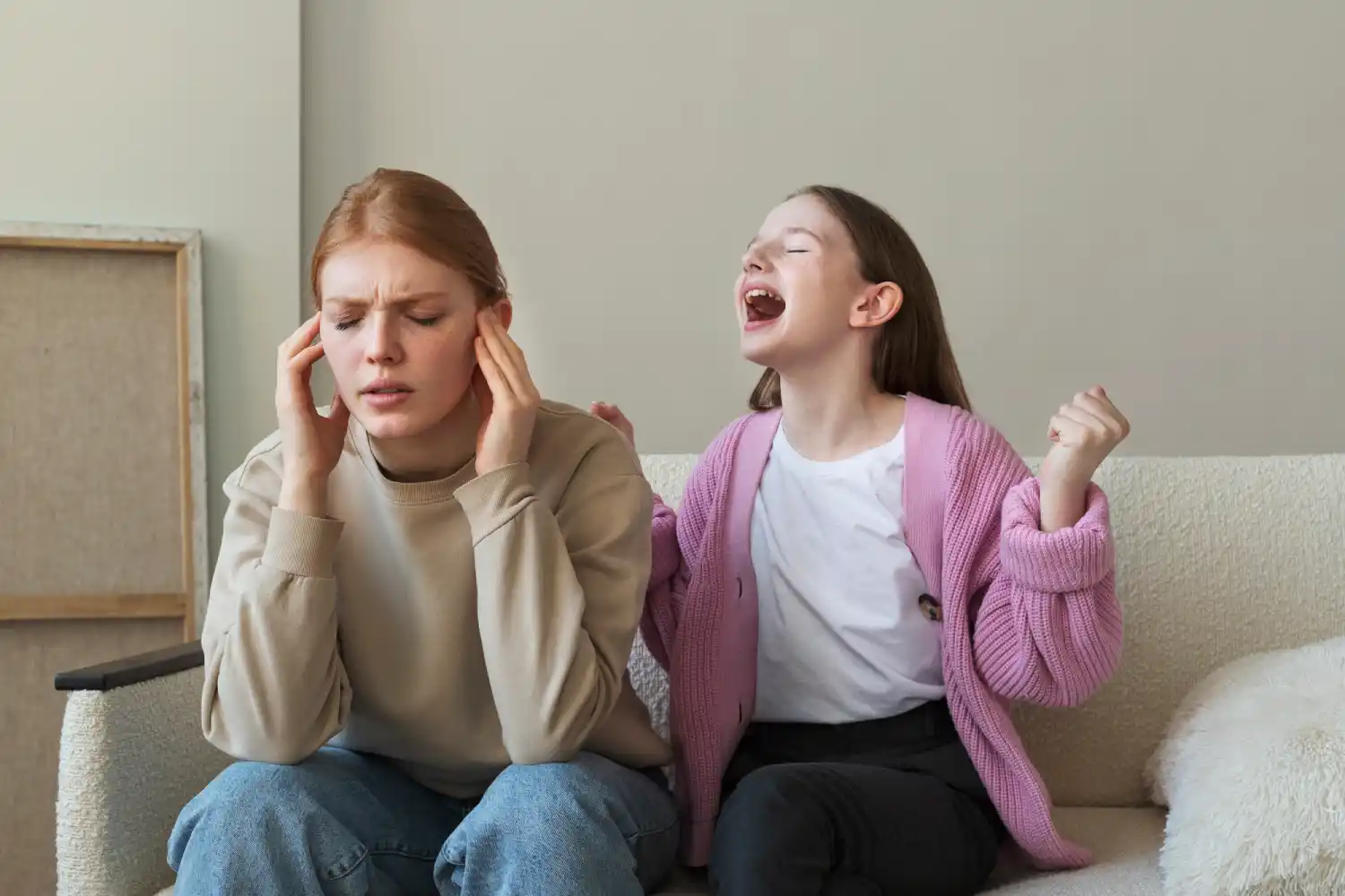 A frustrated woman holding her head while a child shouts beside her, representing the emotional overwhelm and stress associated with ADHD in family dynamics.