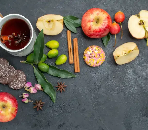 Natural foods that lower blood pressure and boost brain health – dark chocolate, green tea, and apples on a table - Save your Brain Wellness