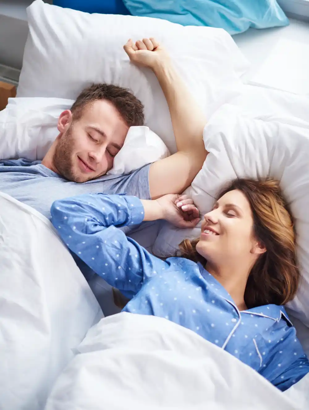 Happy couple sleeping peacefully in bed after successfully completing a sleep restriction therapy program to reset their circadian rhythm - Save your Brain Wellness