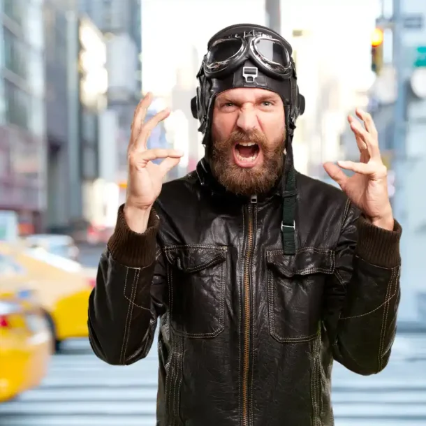 Bearded man showing intense fear or anger reaction in urban environment, representing subconscious emotional response I Save your Brain wellness