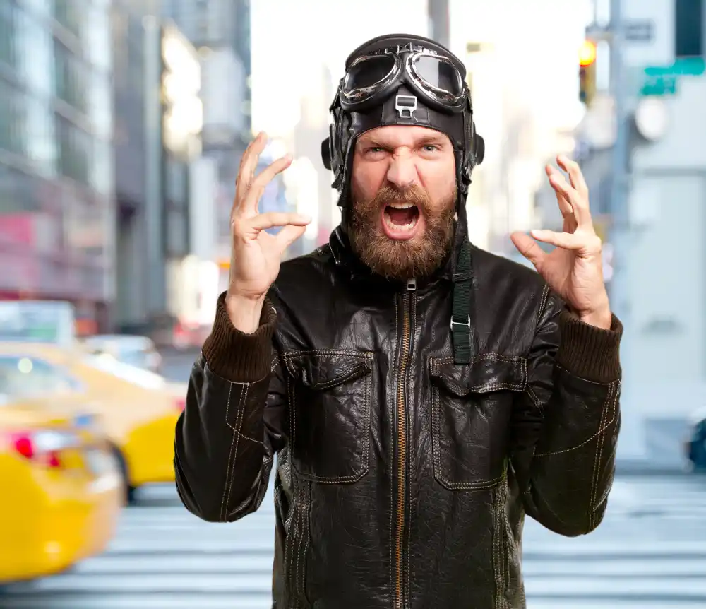Bearded man showing intense fear or anger reaction in urban environment, representing subconscious emotional response I Save your Brain wellness