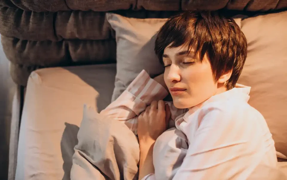 Woman peacefully sleeping, illustrating the role of deep rest in memory improvement and brain health.